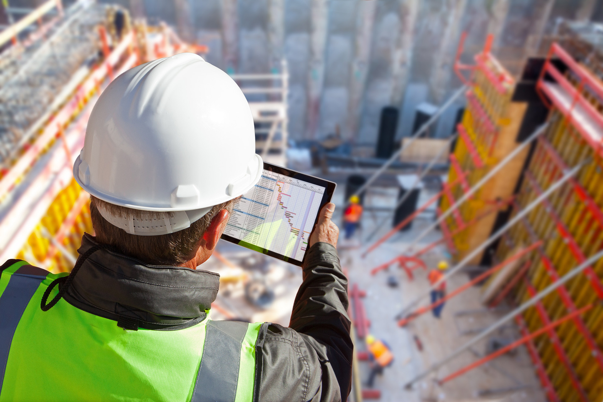 Man using ERP software on Tablet at Job Site image