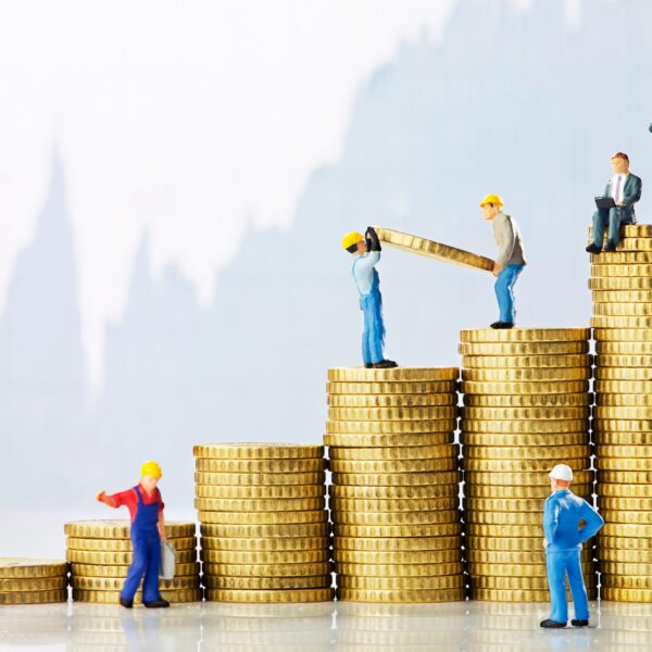 Construction Accounting, construction figurines climbing increasingly large stacks of coins